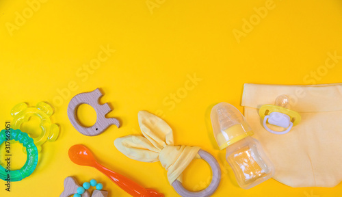 Fotografie Accessories for newborns on a yellow background. Selective focus.