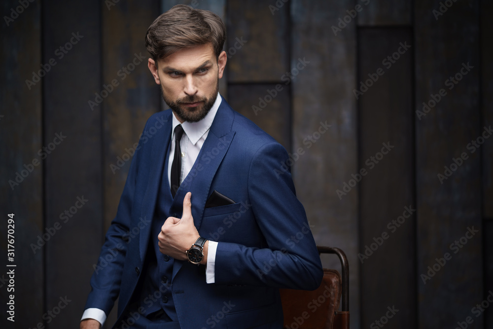 indoor photo of young handsome stylish businessman wearing suit indoor photo of young handsome stylish businessman wearing suit