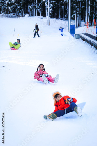 Asian girls playing snow happily in japan. ,  Children playing in the snow , Children playing in the snow happily.Asian boy playing snow happily in japan.