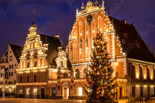 Christmas postcard of Riga. House of the Blackheads with Christmas tree at night, old town Riga, Latvia