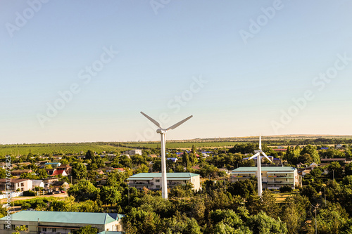 Krasnodar region, Temryuk district, Kuchugury, Russia. Kuchugury resort village at coast Azov sea. Wind turbines in rural area. Bird's eye view. photo
