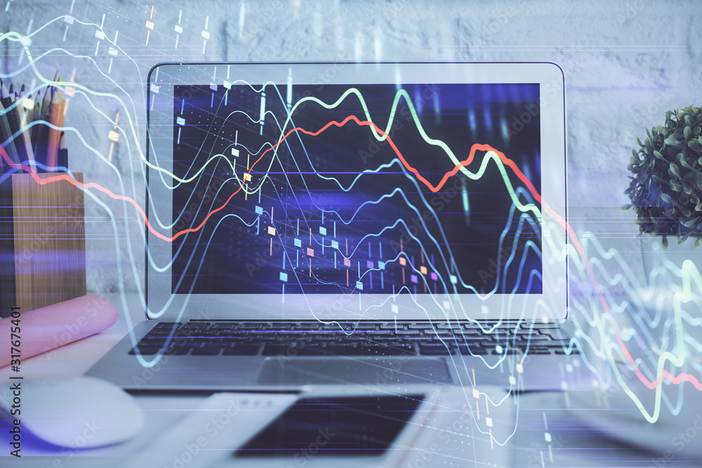 Forex Chart hologram on table with computer background. Double exposure. Concept of financial markets. Forex Chart hologram on table with computer background. Double exposure. Concept of financial markets.