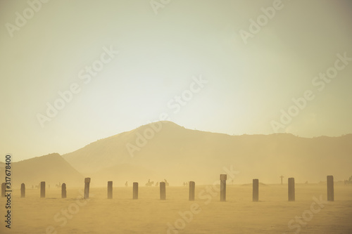 Dust and Sandstorm in desert, Light shines through the rising grains of a sandstorm in the vast hot desert, disaster, A storm in the desert