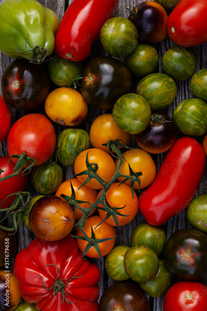 Naklejka Red, green, yellow tomatoes on wooden background