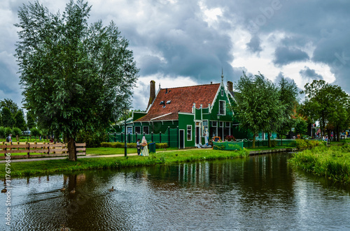 Zaanse Schans, Holland, August 2019. North-east of Amsterdam is a small community located on the quay of the Zaan river. View of the charming village of wooden houses. Cloudy day. © Massimo Parisi