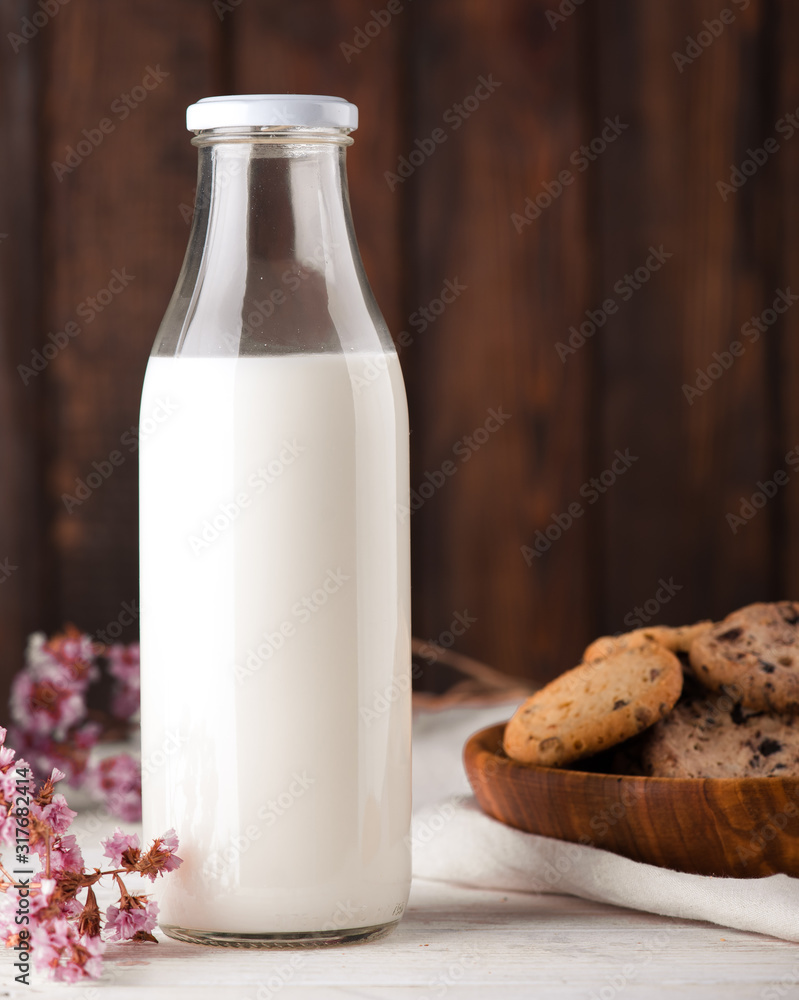 Chocolate chip cookies with milk on burlap and rustic wooden table Chocolate chip cookies with milk on burlap and rustic wooden table