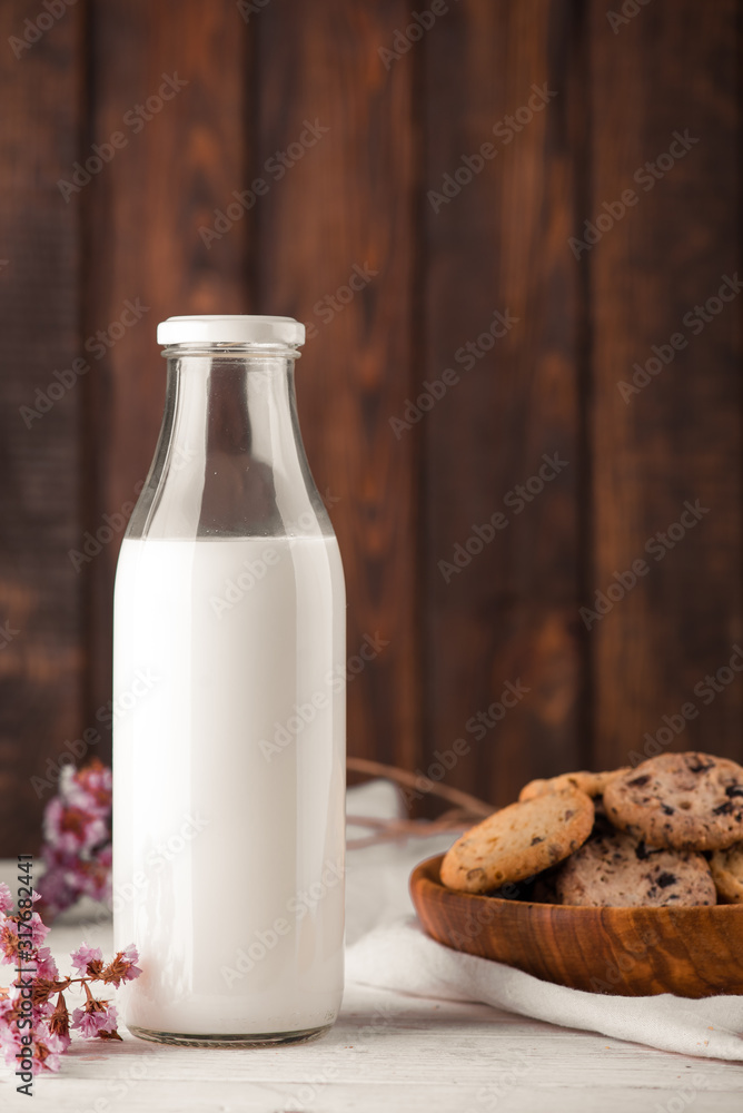 Chocolate chip cookies with milk on burlap and rustic wooden table Chocolate chip cookies with milk on burlap and rustic wooden table
