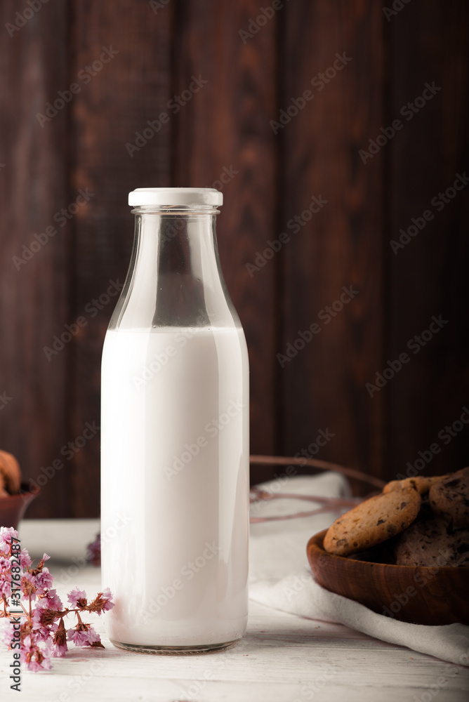 Chocolate chip cookies with milk on burlap and rustic wooden table Chocolate chip cookies with milk on burlap and rustic wooden table