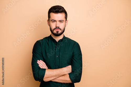 Portrait of confident cool entrepreneur masculine brutal guy cross hands ready solve start-up problems wear modern clothes isolated over beige color background