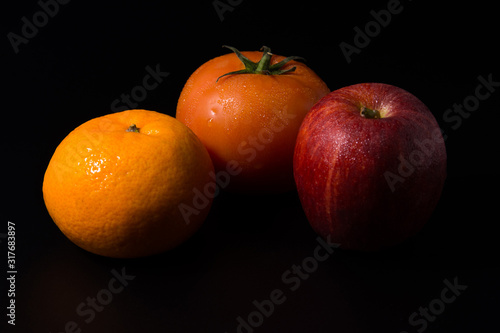 Three fresh fruits isolated on a black background