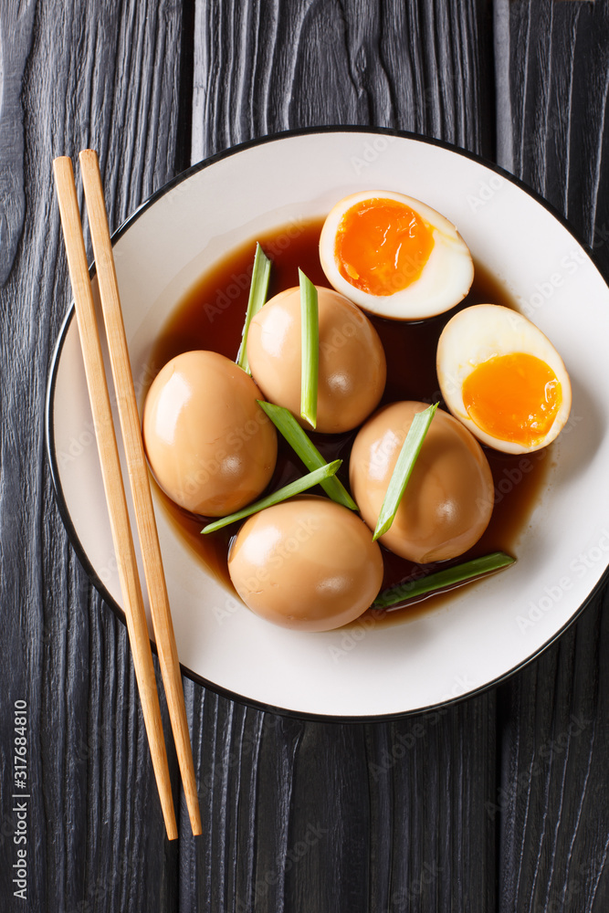 Recipe of delicious japanese nitamago eggs close-up in a plate. Vertical top view Recipe of delicious japanese nitamago eggs close-up in a plate. Vertical top view