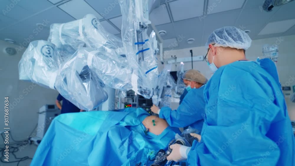 Team surgeon at work in operating room. Modern equipment in operating room. Surgical system da Vinci Team surgeon at work in operating room. Modern equipment in operating room. Surgical system da Vinci