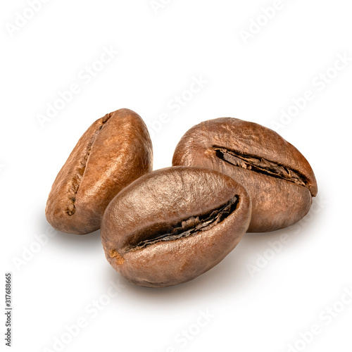 Three coffee beans isolated on white background. Dark roasted coffe grain. Macro, close up