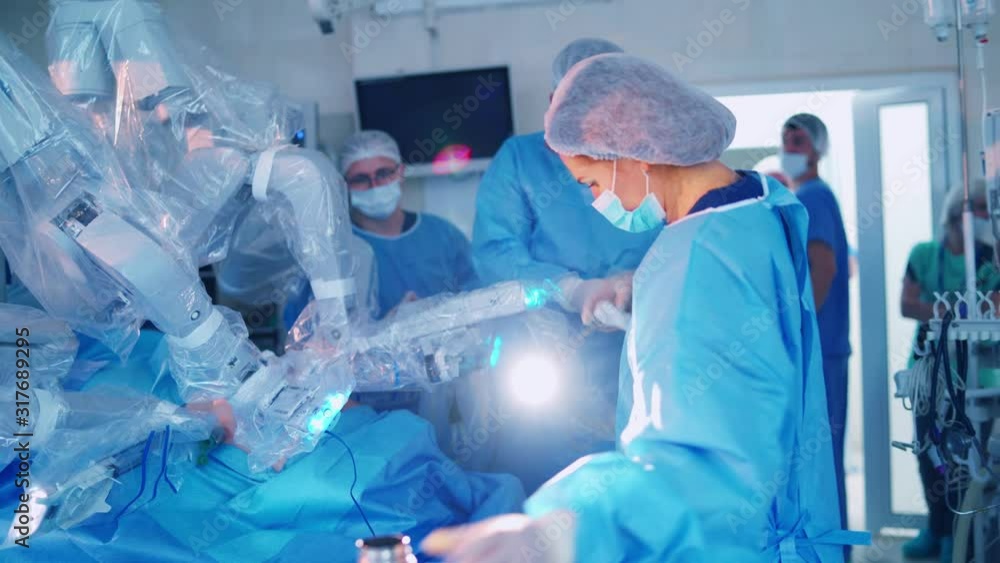 Team surgeon at work in operating room. Modern equipment in operating room. Surgical treatment of cancer Team surgeon at work in operating room. Modern equipment in operating room. Surgical treatment of cancer