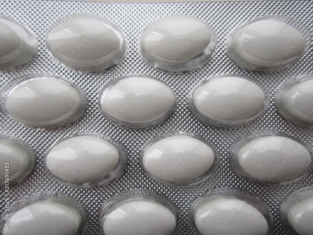 pack with vitamins in the form of oval white tablets pack with vitamins in the form of oval white tablets