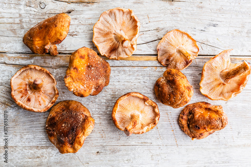 Fresh Shitake mushrooms on a wooden background.