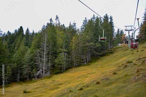 Emtpy chairlift in Mittenwald. Mountains and hills with in Summer with green trees and grass