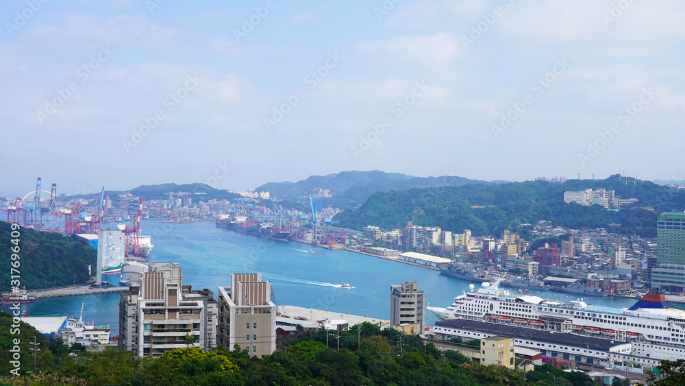 View of the passenger and cargo port in Taiwan. Panorama of the Asian port city. blue water of the pacific ocean in the bay of keelung. green hilly island