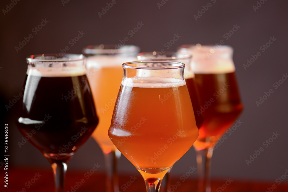 Three glasses with different beer on wooden table in a bar. Food photography concept, with copy space Three glasses with different beer on wooden table in a bar. Food photography concept, with copy space