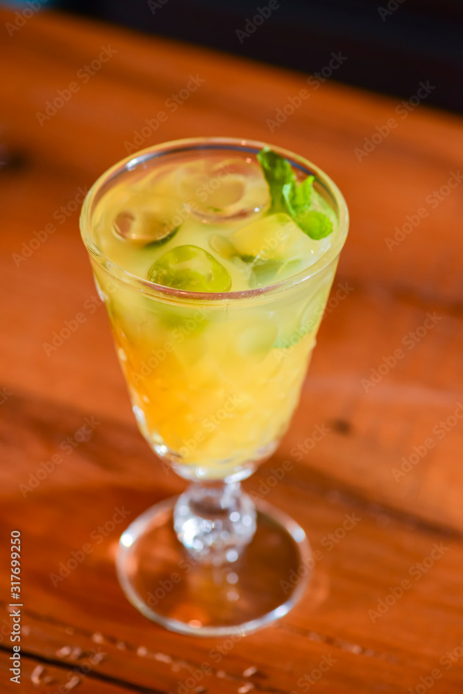 Cider, mulled wine made from white wine in a glass on a wooden table with blurred background. Cider, mulled wine made from white wine in a glass on a wooden table with blurred background.