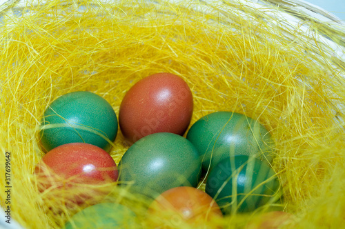 Colored Easter eggs in basket. Selective focus.