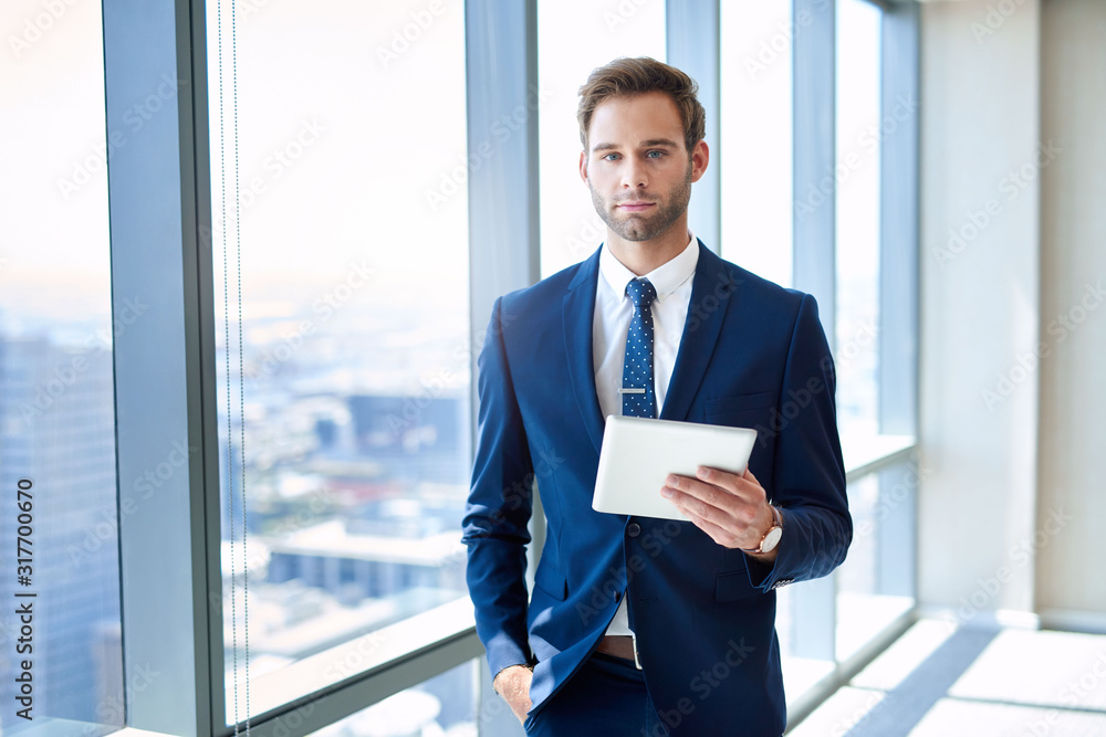 Stylish business executive in modern suit holding digital tablet Stylish business executive in modern suit holding digital tablet