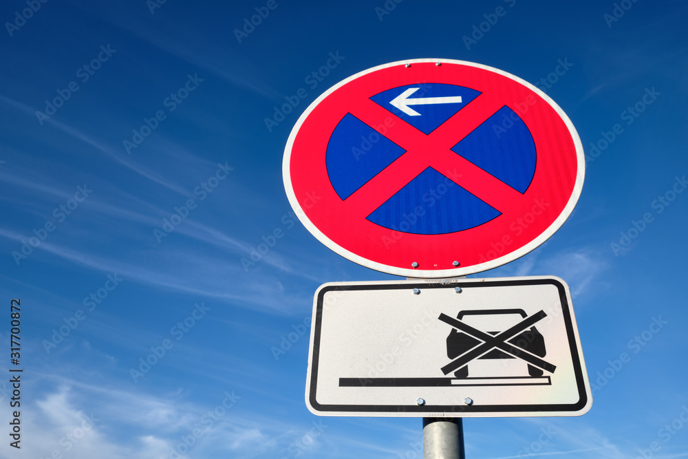 Red and blue traffic sign in front of beautiful blue sky says absolute no stopping here also on the hard shoulders. Seen in Bavaria, Germany near Oedenberg in January Red and blue traffic sign in front of beautiful blue sky says absolute no stopping here also on the hard shoulders. Seen in Bavaria, Germany near Oedenberg in January