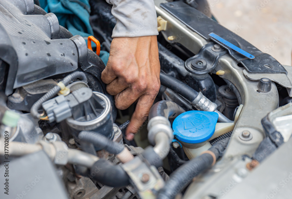 Selective focus of Mechanic fixing cooling water pipe at car engine, Car repair concept Selective focus of Mechanic fixing cooling water pipe at car engine, Car repair concept