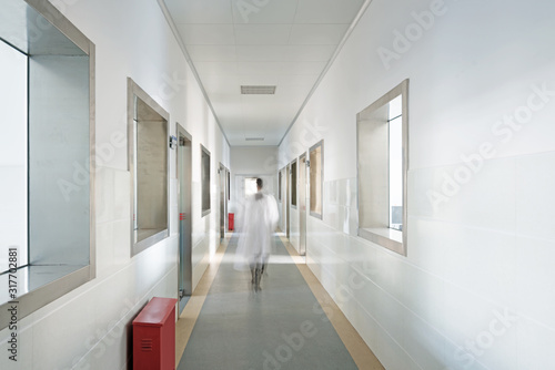 people walking in the corridor of hospital laboratory, blur motion.