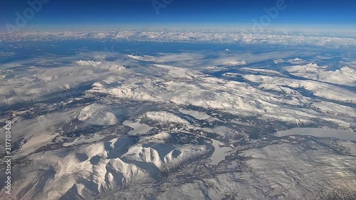flight over snow capped mountains