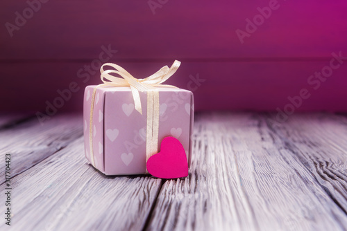 Gift box and pink heart over pink blur background. Valentines day concept