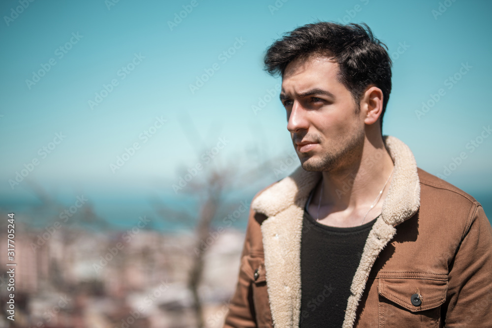 The young jacket man posing in outdoors. The young jacket man posing in outdoors.