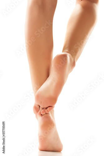 Beautifully groomed female feet on a white