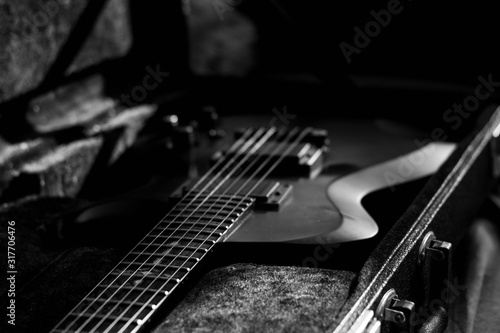 Black matte guitar in a case closeup