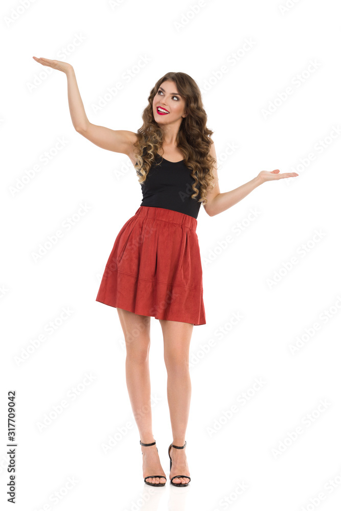 Beautiful Young Woman In Mini Skirt And High Heels Is Holding Hands Raised And Comparing Something Beautiful Young Woman In Mini Skirt And High Heels Is Holding Hands Raised And Comparing Something