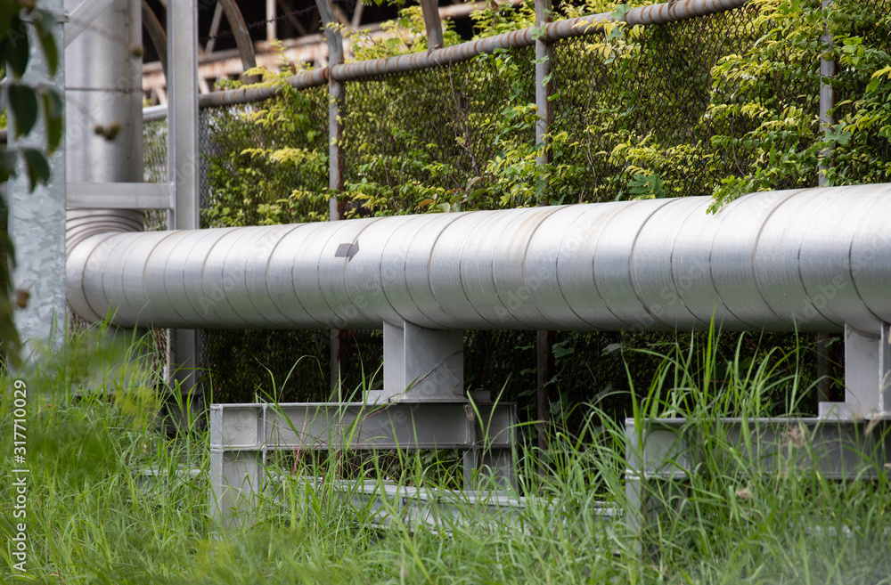 industrial pipe rack on steel structure. outdoor steel pipe with silver insulation in factory. industrial pipe rack on steel structure. outdoor steel pipe with silver insulation in factory.