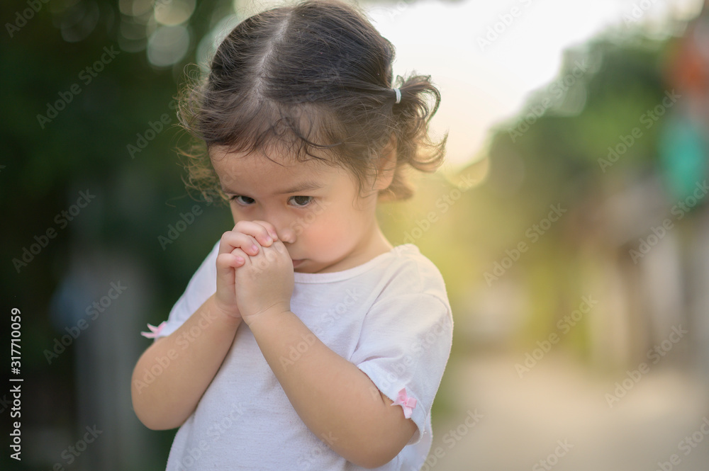 Cute asian little girl closed her eyes and praying in the morning. Little asian girl hand praying,Hands folded in prayer concept for faith,spirituality and religion. Cute asian little girl closed her eyes and praying in the morning. Little asian girl hand praying,Hands folded in prayer concept for faith,spirituality and religion.