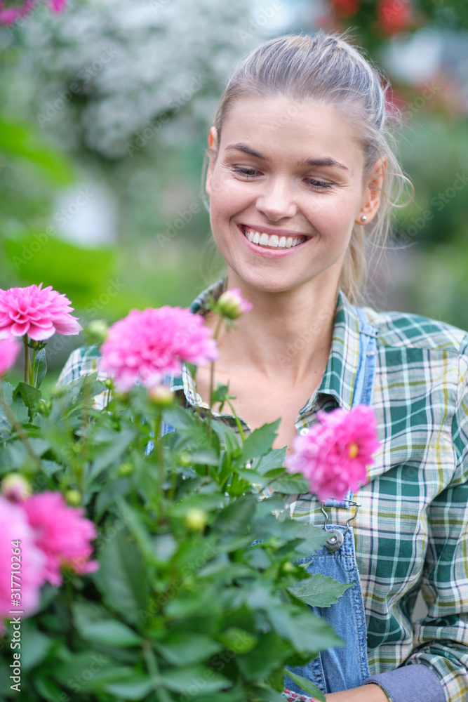 Florists woman working with flowers at a greenhouse. Florists woman working with flowers at a greenhouse.