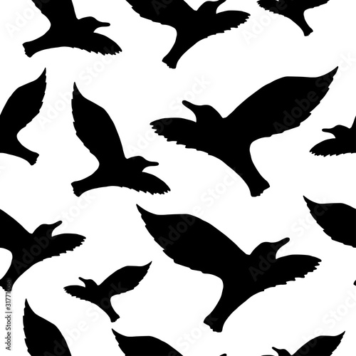 Seamless pattern with the silhouette of a flying seagull on a light sky background. Dark ink hand drawn logo in art style vintage engraving graphic style.