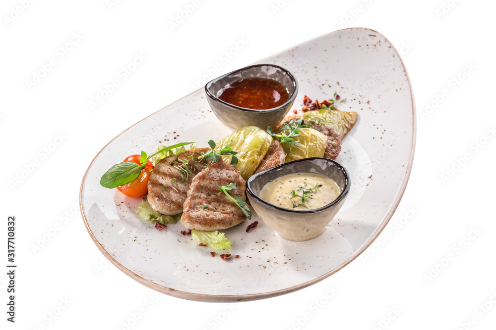 Grilled meat with baked pepper and tomato sauce on white plate isolated on white background