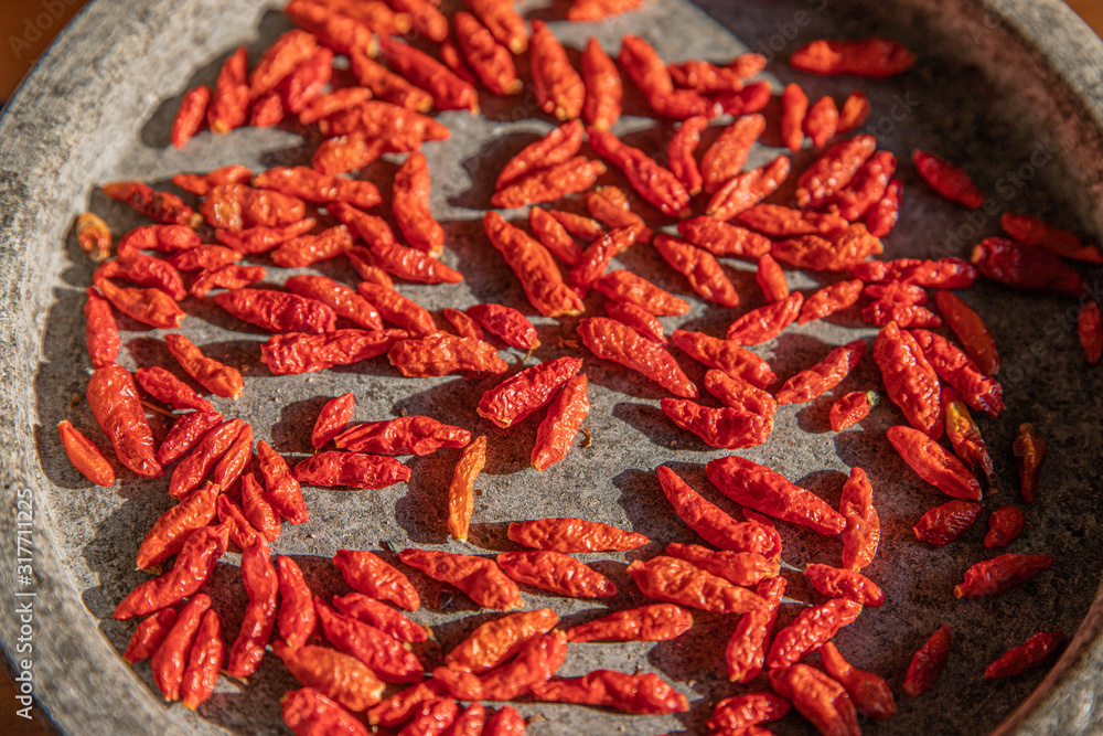 Dried small red chilies in a stone bowl Dried small red chilies in a stone bowl