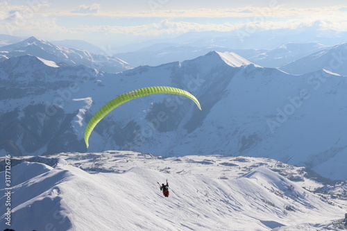 paragliding at the top of snow mountains
