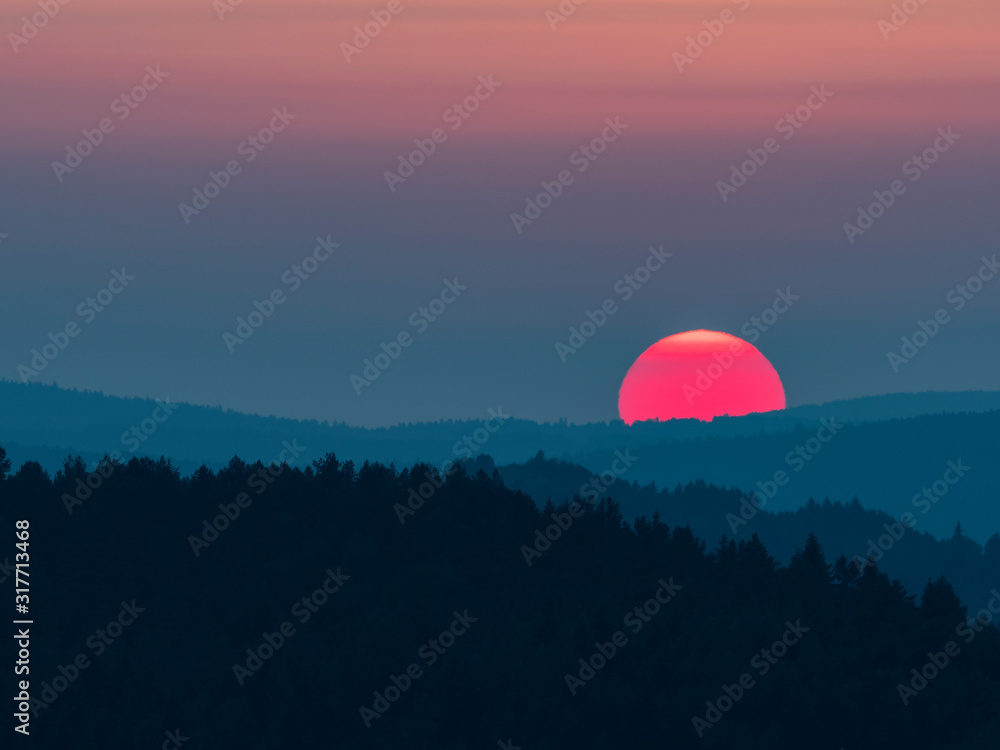 Sunset in the mountains with full disk of sunset under the horizon. Magical sunset in the Carpathians, orange sky, full disk of sunset. Sunset in the mountains with full disk of sunset under the horizon. Magical sunset in the Carpathians, orange sky, full disk of sunset.