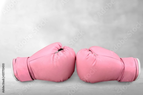 Pink sport boxing gloves on desk © BillionPhotos.com