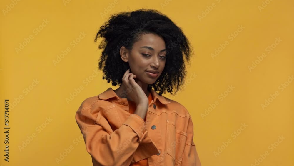 smiling african american woman holding ax isolated on yellow smiling african american woman holding ax isolated on yellow