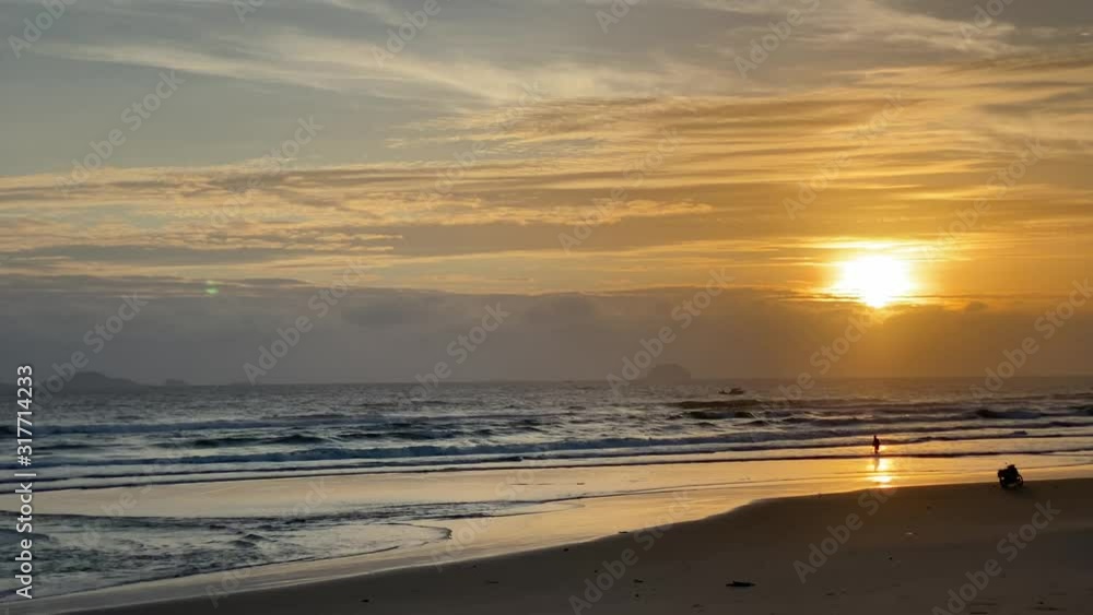 4K video. Dawn at sea, morning on the beach, orange dawn. Waves on a sandy tropical beach. Golden sunset on a tropical beach. Waves at dawn. Empty beach, nobody on the sea 4K video. Dawn at sea, morning on the beach, orange dawn. Waves on a sandy tropical beach. Golden sunset on a tropical beach. Waves at dawn. Empty beach, nobody on the sea