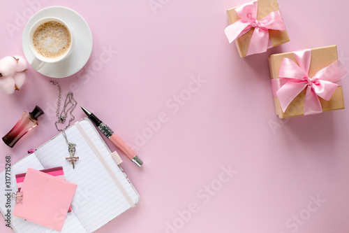 Still life fashion woman, girl, student on a trendy pink background. Overhead of essentials for a modern young man. Notebook, calculator, perfume, powder, glasses, watches, stylish headphones. flat