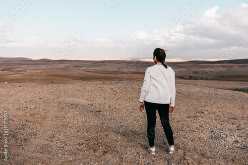 Lonely woman on a rocky desert near of Marrakech