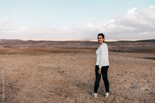 Lonely woman on a rocky desert near of Marrakech