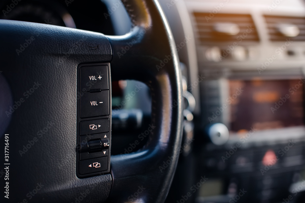 Control buttons on the steering wheel in modern car.